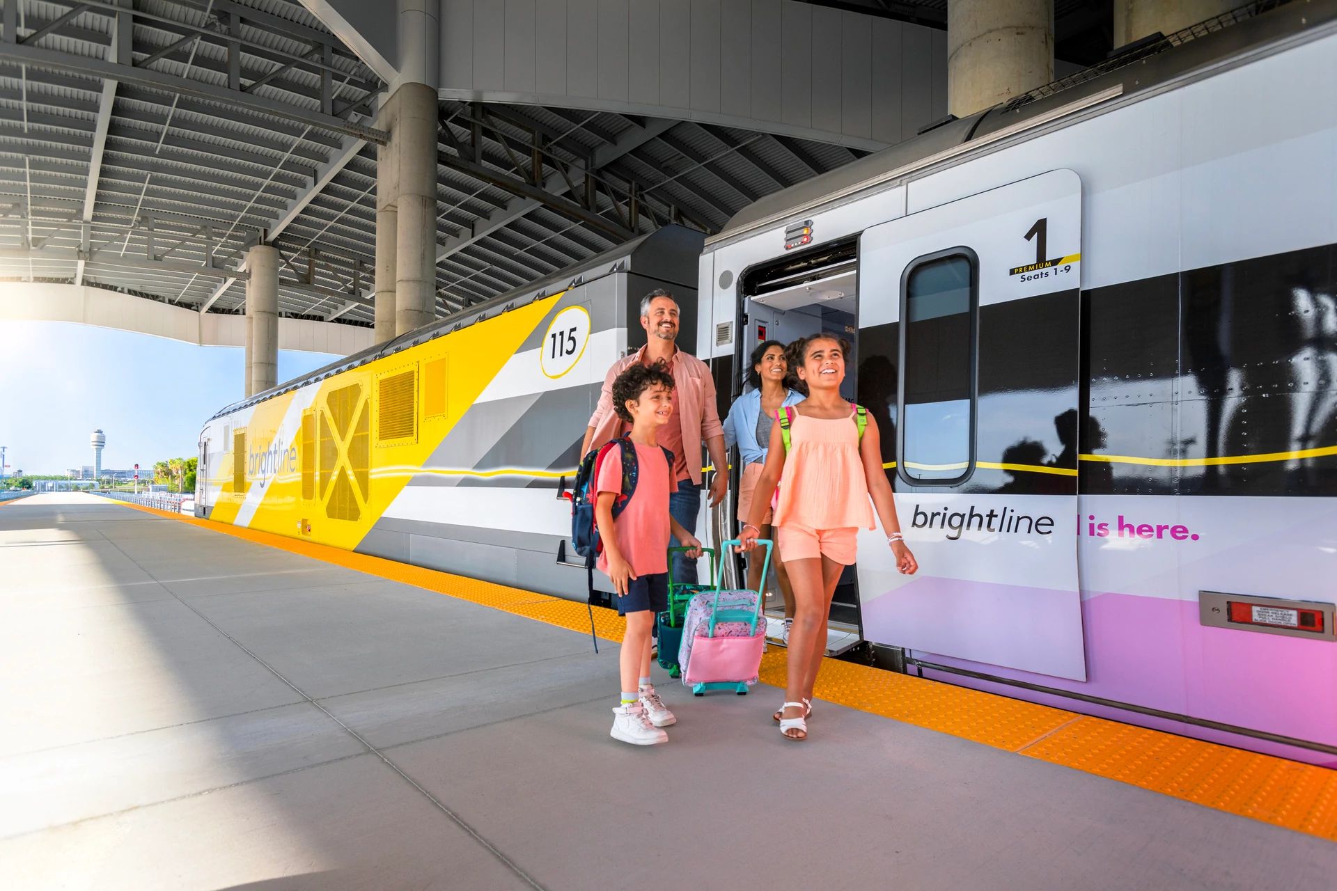 A family exits a Brightline train